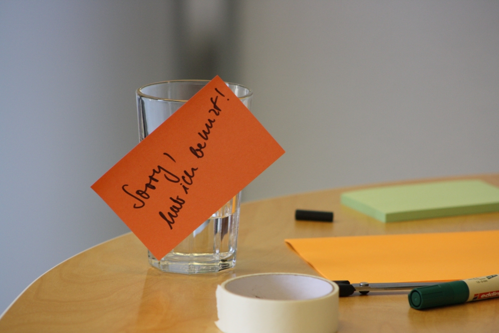 Benutztes Wasserglas Ein Glas Wasser mit der Notiz "Sorry, hab ich benutzt!"